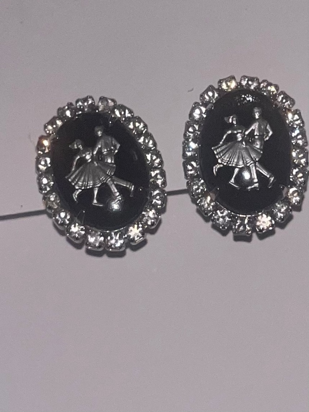 Black Victorian cameo clip on earrings. Surrounded by crystals.